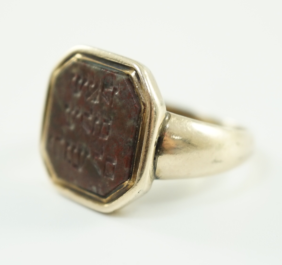 Judaica: A 19th century gold and jasper set ring, the stone carved with Hebrew script